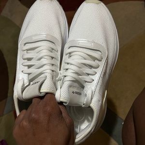Woman’s white Adidas